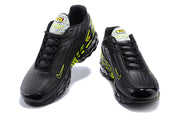 Front and top view of the pair of black and volt Nike Air Max Plus sneakers.