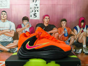 Side view of orange and black Nike basketball shoes with a pink-and-yellow logo detail.