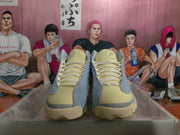 Front view showing pale yellow tongues and laces, gray overlays, and high-top construction