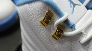 Close-up of the gold-tone lace hardware and blue trim.