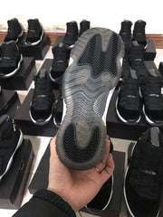 Bottom view of the sneaker showing a translucent outsole with patterned traction sections.