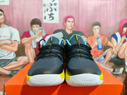 Front view of black and gray Nike basketball shoes with yellow accents and white textured outsoles