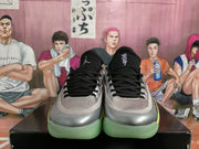 Front view of silver and black Jordan basketball sneakers with black laces, mesh tongues, and pale green outsoles.