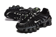 Pair of black Nike Shox TL sneakers shown in angled views.