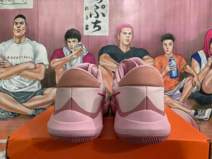 Rear view of pink Nike basketball shoes showing heel details and outsole tread.
