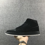 Side profile of the black high-top sneaker with its contrasting white outsole.