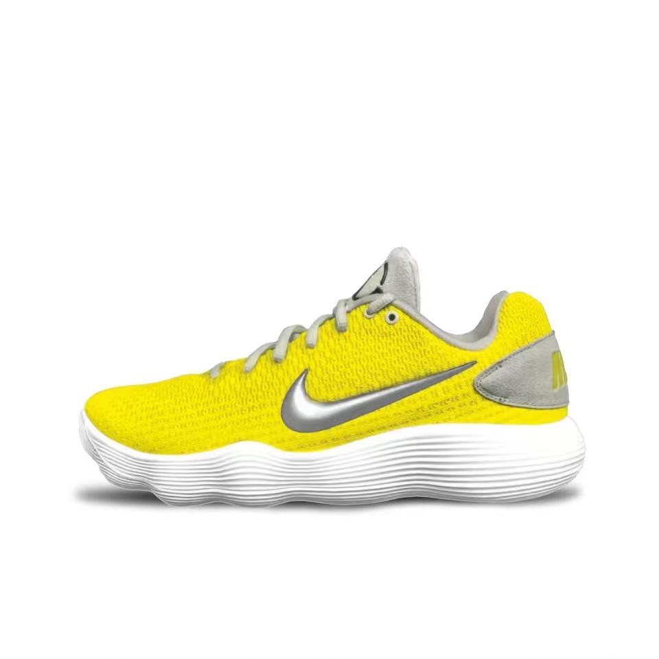 Side view of a low-cut yellow Nike basketball shoe with a silver Swoosh, gray accents, and a white ridged sole