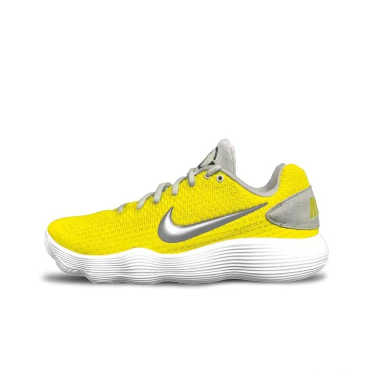 Side view of a low-cut yellow Nike basketball shoe with a silver Swoosh, gray accents, and a white ridged sole