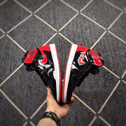 Pair held together to show the black and red side panels, white midsoles and red outsoles.