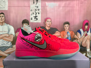 Side view of a pink and red basketball shoe with black graphic details