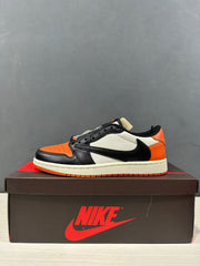 Side profile showing the black Swoosh, white side panel, orange heel and orange outsole.