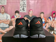 Rear view showing orange Adidas heel logos and light-colored outsole tread.