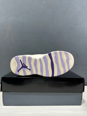 Outsole view showing cream and purple segmented sections, a Jumpman logo, and basketball-themed text.