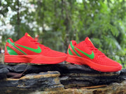 Pair of red and green Nike Kobe 6 shoes shown from the side