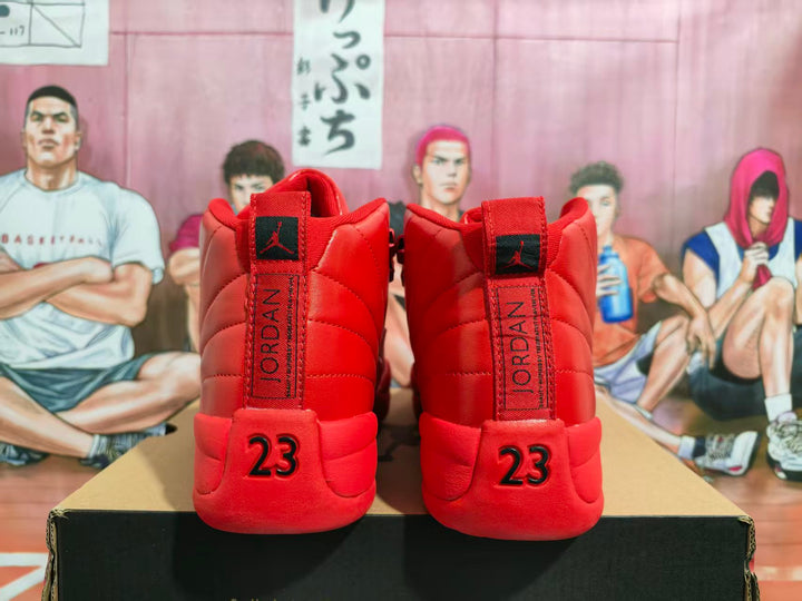 Rear view of bright red Jordan high-top sneakers showing Jumpman tongue labels, Jordan lettering, and number 23 heel details.