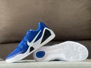 Side and outsole display showing the white patterned outsole, blue traction insert, and black heel panel.