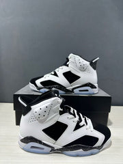Angled view of the pair highlighting the white upper, black paneling, and speckled midsole.