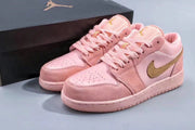 Pair of pink low-top Jordan sneakers displayed with a black shoebox.