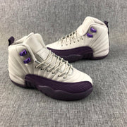Air Jordan 12 sneakers shown from the side with off-white panels and deep purple overlays