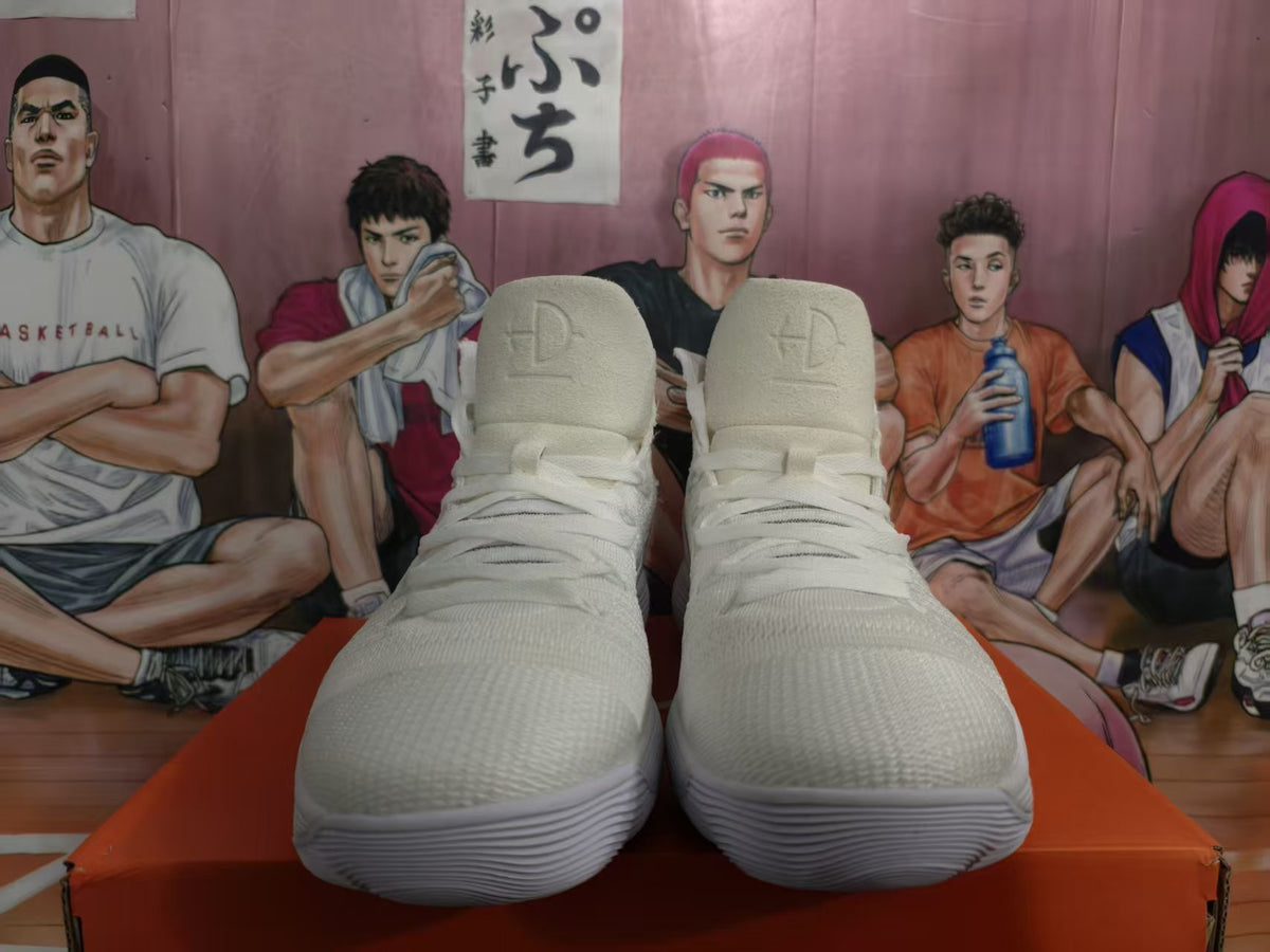 Front view of white Nike high-top basketball sneakers with lace-up closure and ankle straps