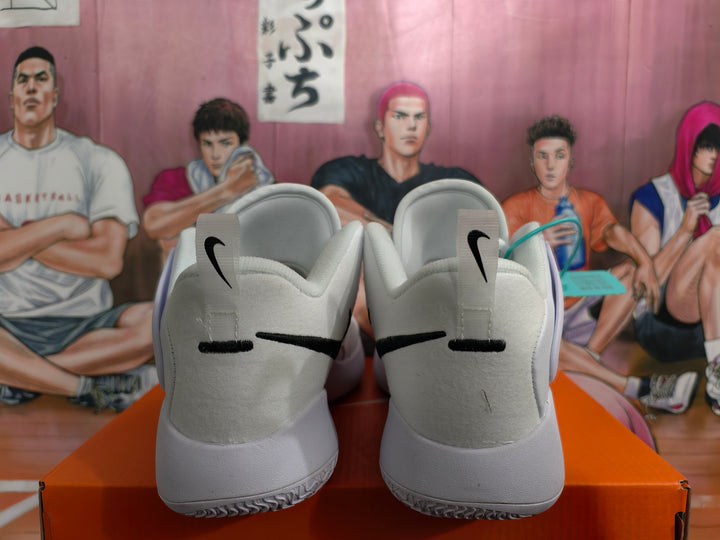 Rear view of white Nike basketball sneakers with black heel Swoosh logos on an orange shoebox.
