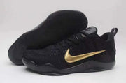 Black Nike Kobe 11 shoe with gold Swoosh and textured outsole.