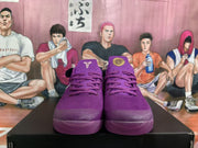 Front view of the purple Nike basketball sneakers showing the laces, perforated tongue areas, and basketball-themed tongue branding.