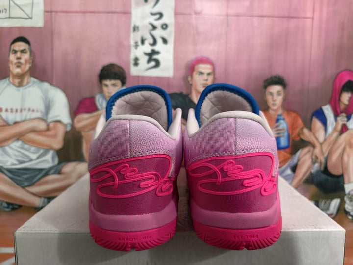 Rear view of pink Nike basketball sneakers showing padded collars, layered heel panels, and textured rubber outsoles.