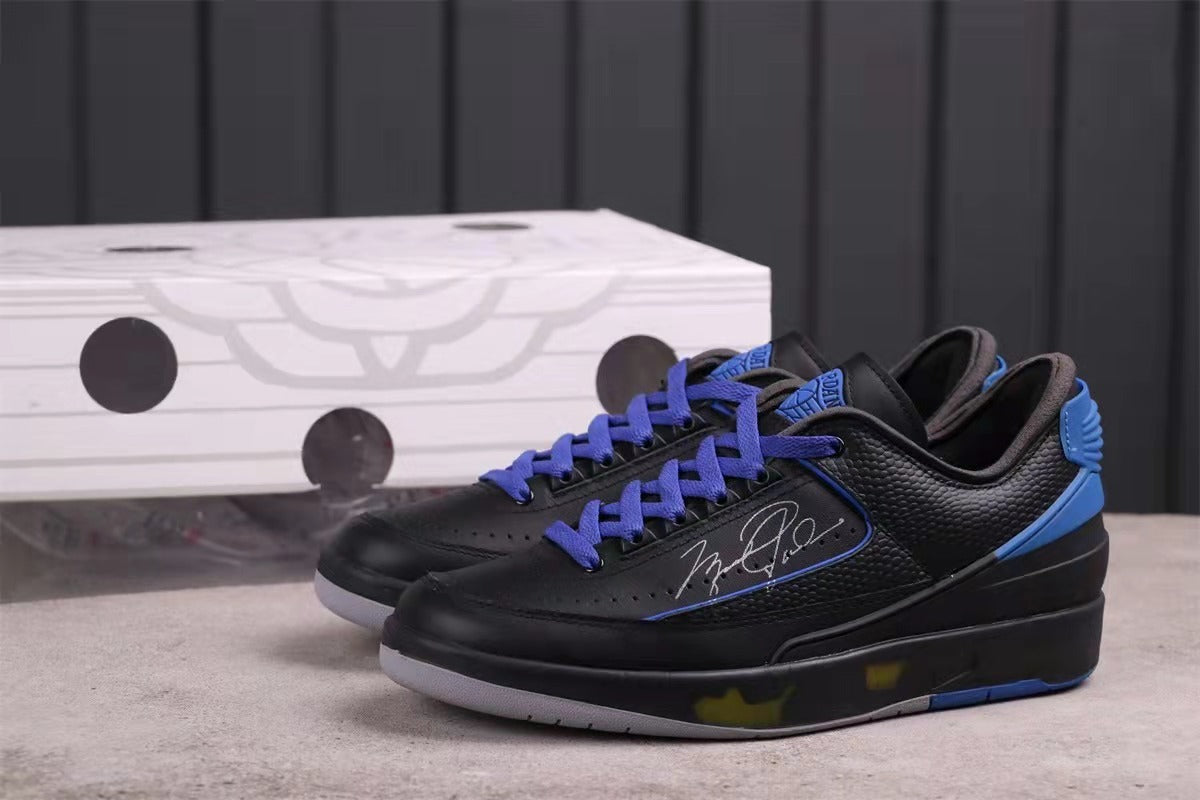 Pair of black and blue low-top sneakers showing purple laces, side graphics, and translucent outsole accents.