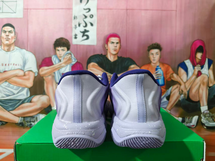 Rear view of purple Nike basketball shoes showing light gray heels and speckled midsoles.
