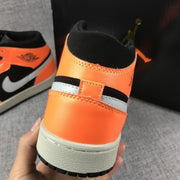 Rear view showing the orange heel panels and layered midsole.