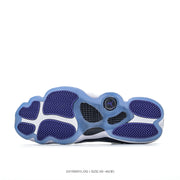 Underside view showing the blue-purple rubber outsole with herringbone-patterned traction sections.