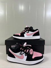 Angled view of the black, white, and pink sneakers highlighting the perforated pink toe box, laces, and side details.