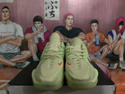 Front view of the pair showing light green uppers, laces, rounded toes, and small red Nike accents.