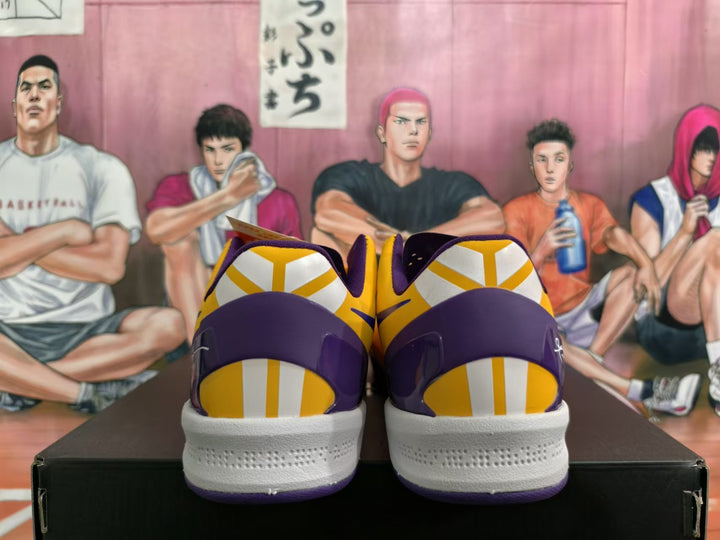 Rear view of yellow and purple Nike basketball shoes with white midsoles