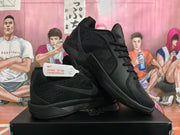 Black Nike basketball shoes shown crossed to display the side Swoosh and low-cut shape