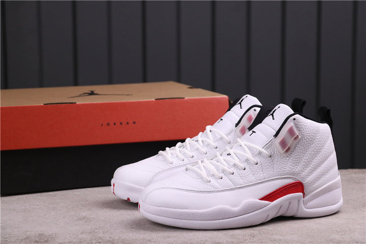 Pair of white and red Jordan 12 high-top sneakers shown with a Jordan shoebox.