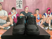 Front view of black sneakers with Tiffany blue tongue logos, black laces, perforated toe panels, and textured toe overlays.