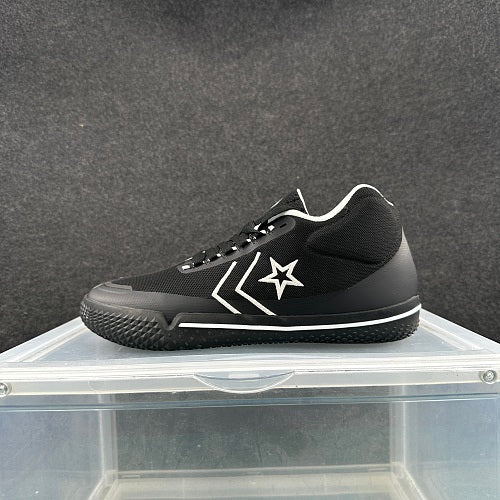 Side view of a black Converse low-top sneaker with white star-and-chevron detailing and a white midsole stripe.