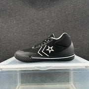 Side view of a black Converse low-top sneaker with white star-and-chevron detailing and a white midsole stripe.