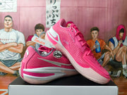 Angled view showing pink Nike basketball sneakers and their side details