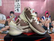 Angled view of the pair showing the textured brown uppers, off-white overlays, Nike Swoosh, and red heel details.