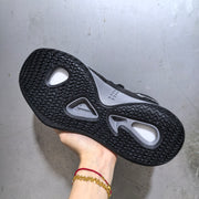 Underside view of the Nike Hyperdunk sneaker showing the black textured outsole with grey traction sections.