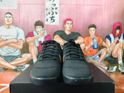 Front view of black basketball shoes with black laces.