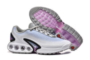 Nike Air Max DN sneakers shown from the side and outsole, with purple outsole sections.