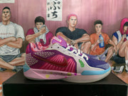 Side view of a colorful Nike basketball shoe with a magenta patterned upper and smiley graphics on the midsole.