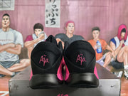 Rear view showing black heel sections with pink embroidered graphics and pink side accents.