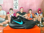 Side profile of a black Nike basketball shoe with a bright blue Swoosh.