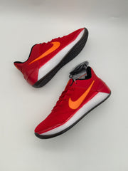 Red Nike basketball sneakers displayed from side and top angles, showing orange Swoosh branding and textured uppers.