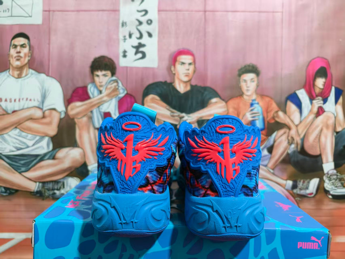 Rear view of blue PUMA basketball sneakers with coral heel details on a branded box